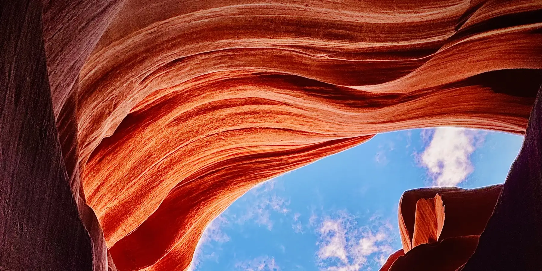Looking up at the sky through the walls of Lower Antelope Canyon