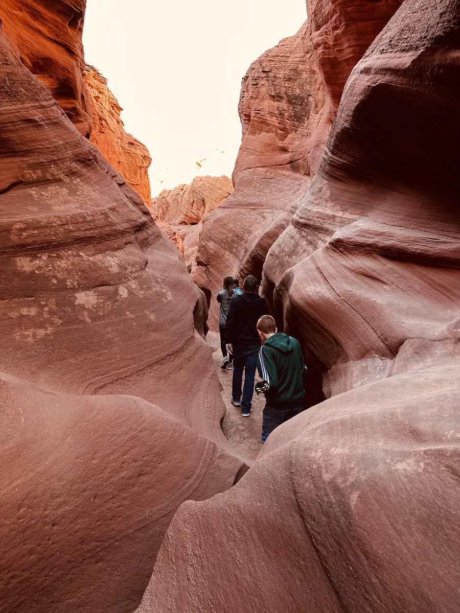 Guests walking through the narrow walls of Owl Canyon