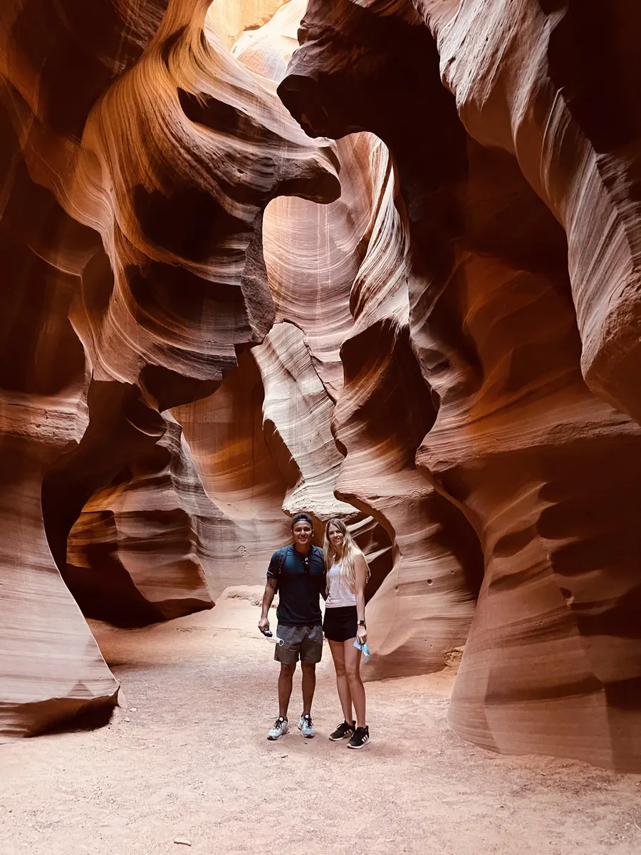 Two guests dwarfed by the sculpted walls of Upper Antelope Canyon
